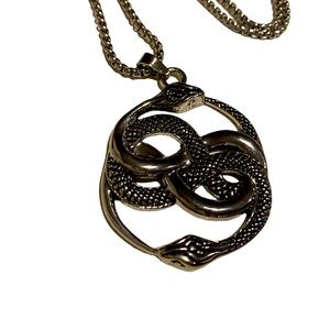 The Never Ending Story Auryn amulet. Silver tone two snakes with 22 1/2” chain.